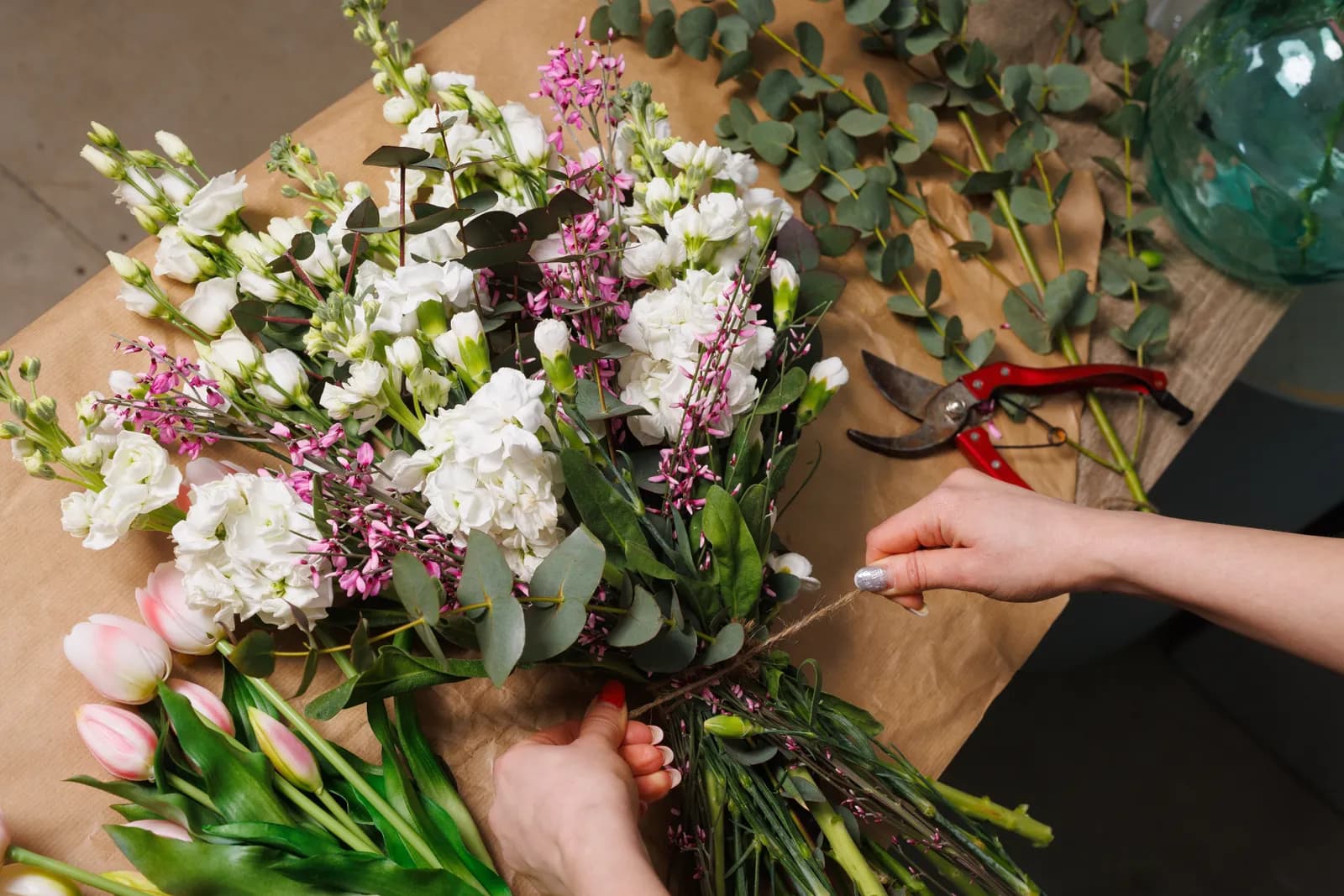 Florist building a bouquet at a workbench
