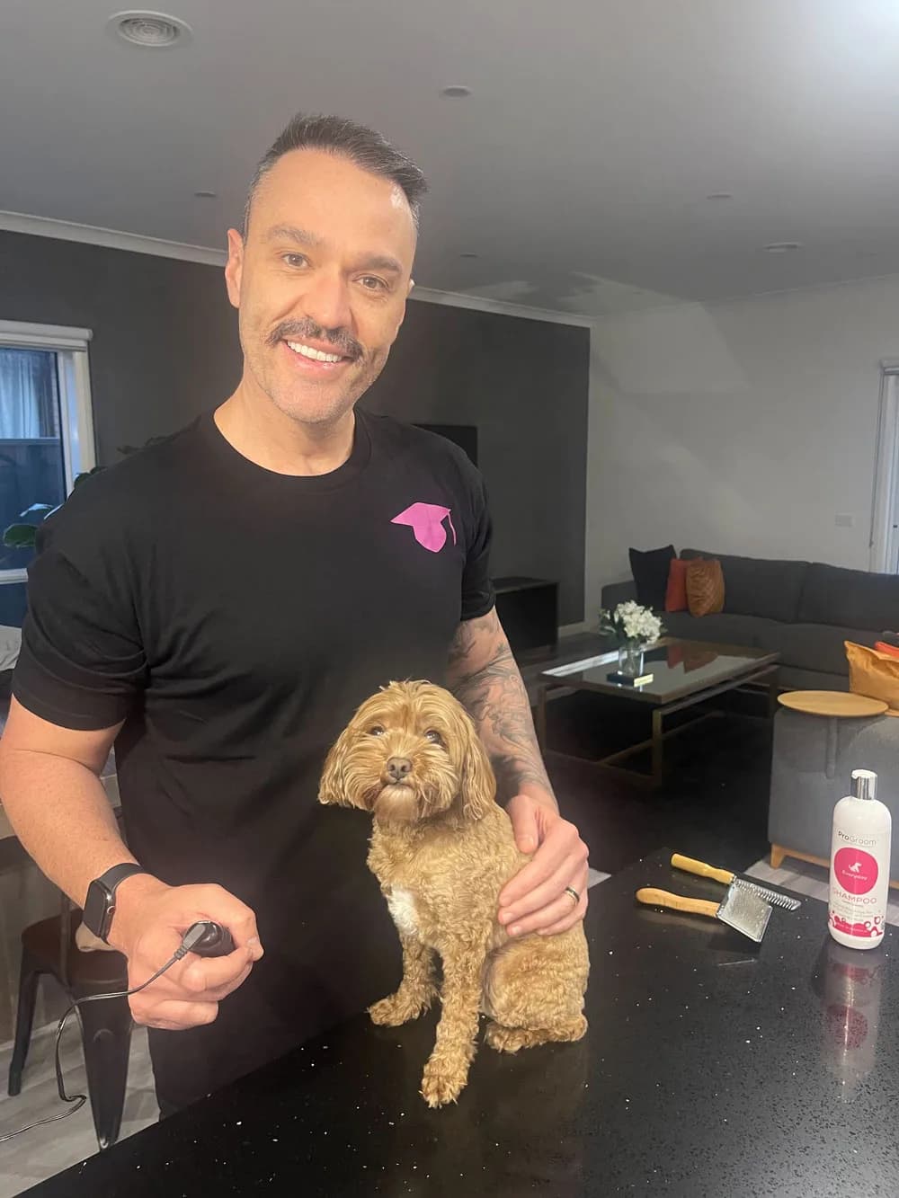 Jacob standing beside a freshly groomed dog